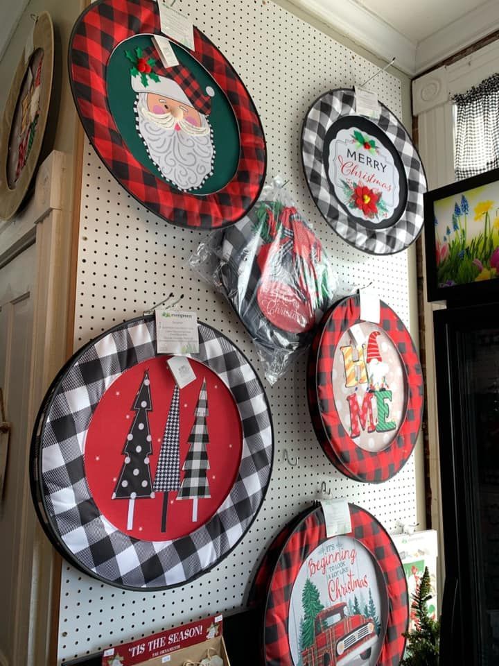 A bunch of christmas plates are hanging on a wall.
