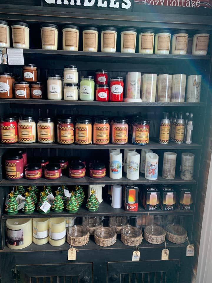 A shelf filled with lots of candles and jars.