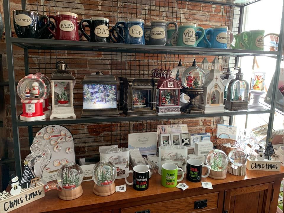 A shelf filled with lots of christmas decorations and mugs.