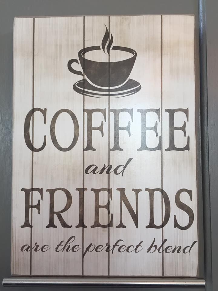 A wooden sign that says coffee and friends are the perfect blend