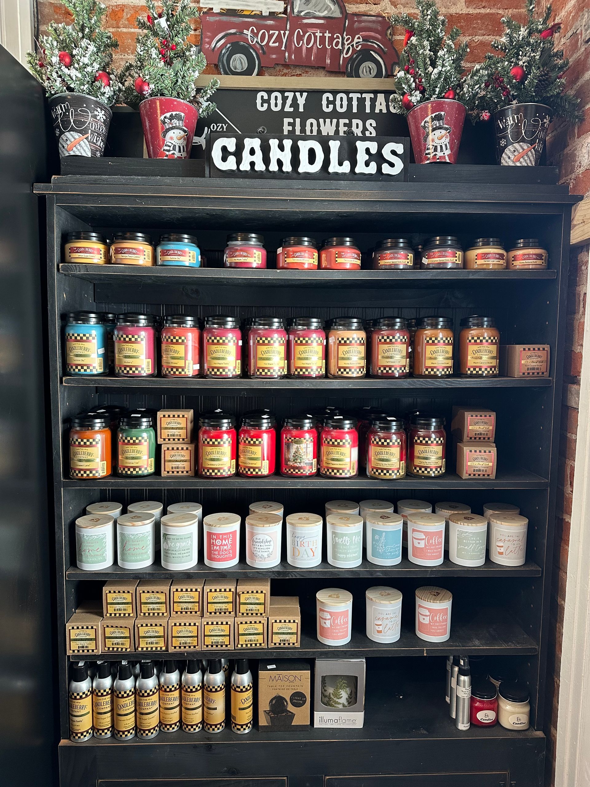 A shelf filled with jars of candles in a store.