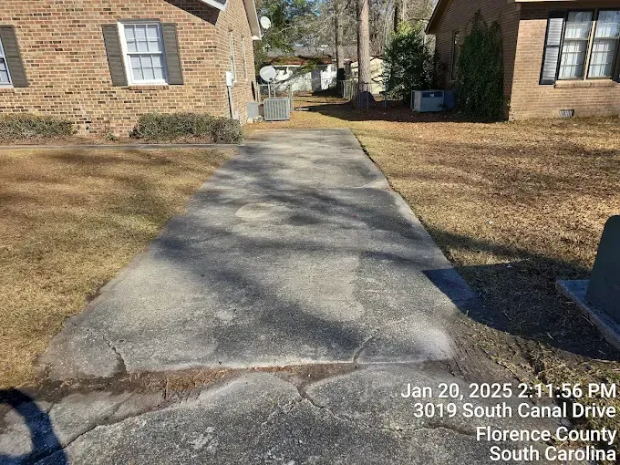 Concrete walkway between two brick buildings on South Canal Drive.