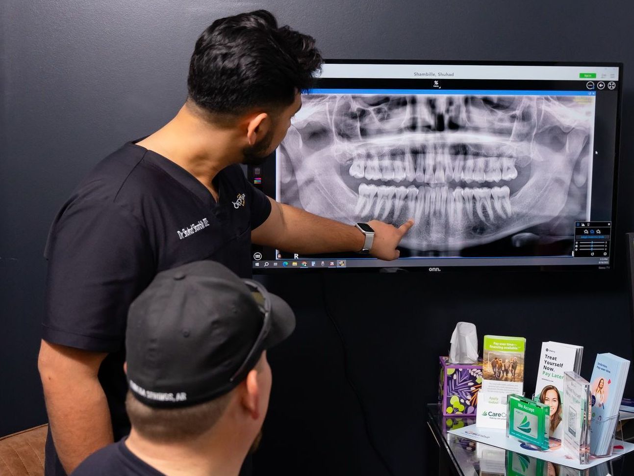 Dentist reviewing x-ray with new patient