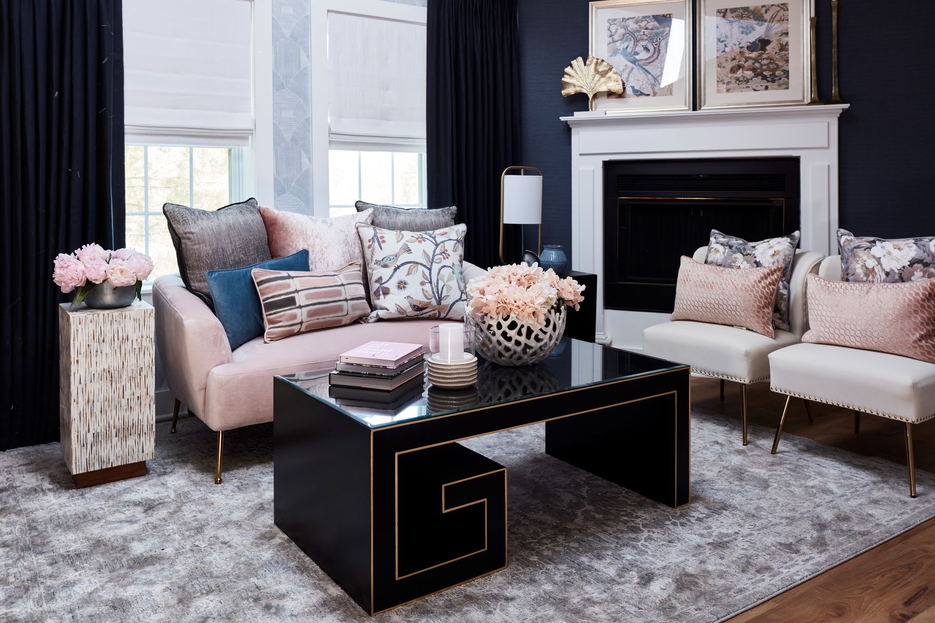 A living room with a couch , chairs , coffee table and fireplace.