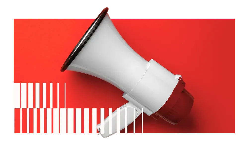 um megafone branco está em cima de uma superfície vermelha.