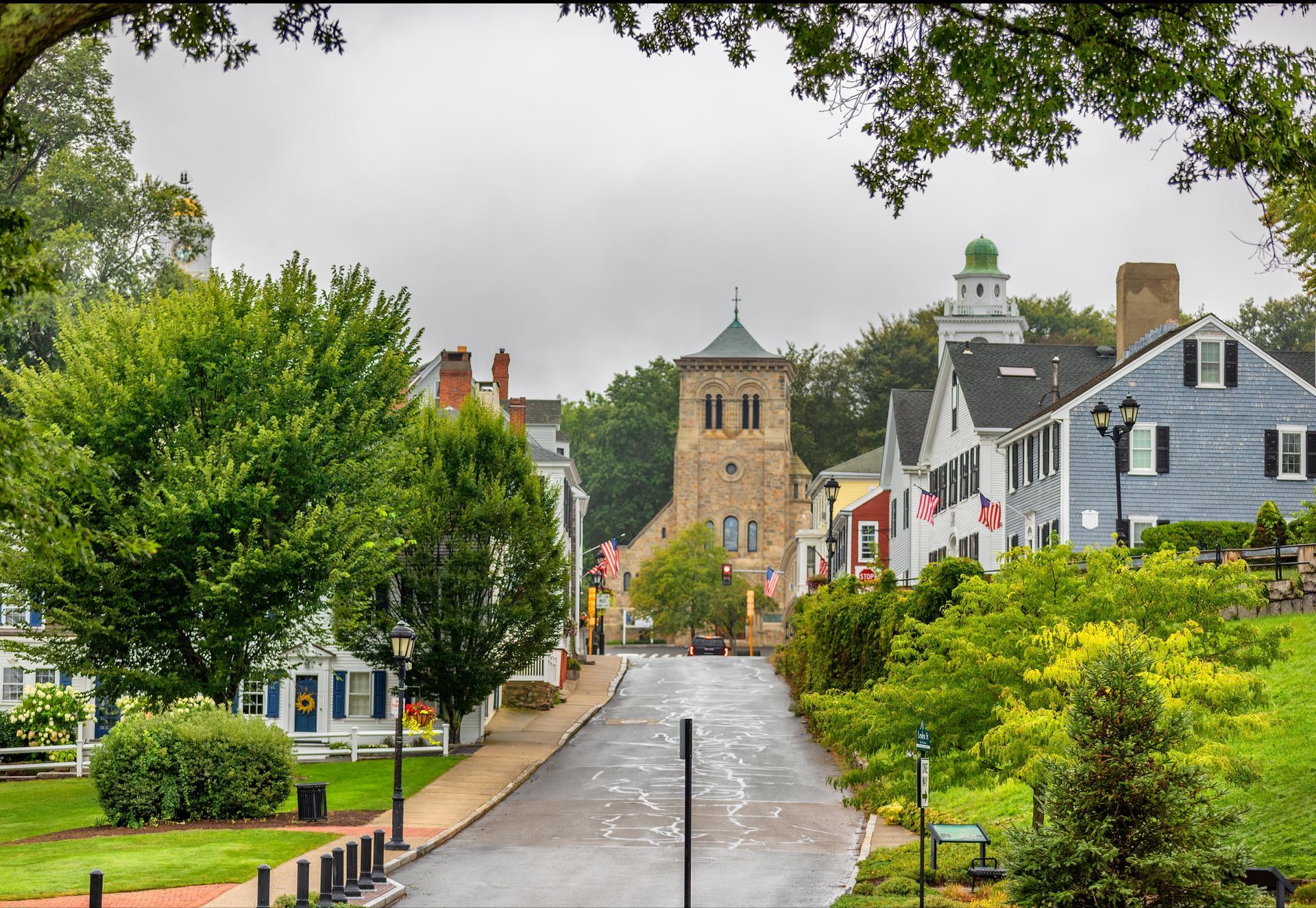 A narrow street with a church in the background