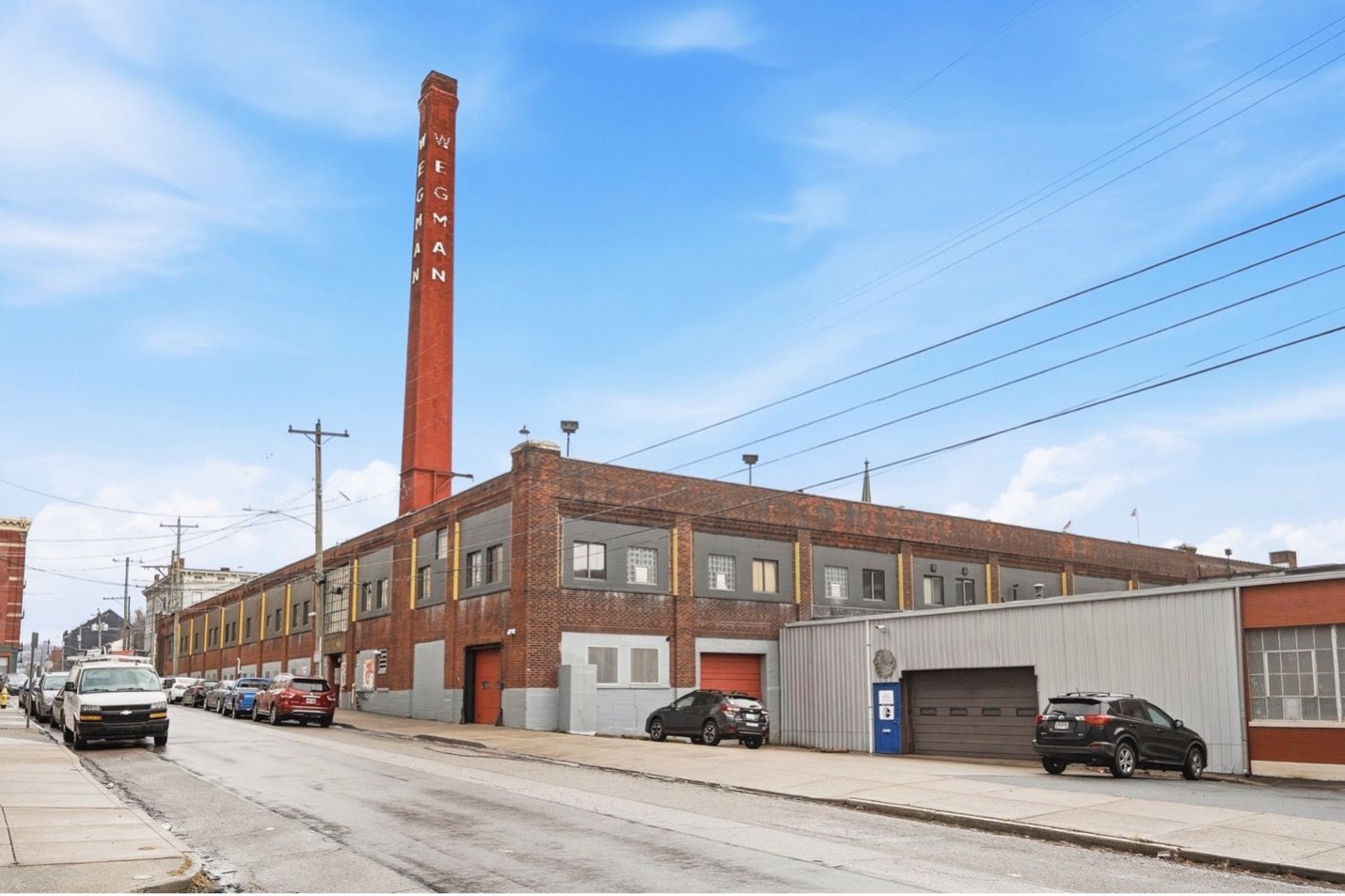 Tokyo Metropolitan Government Building against a bright blue sky. Tall, multi-towered skyscraper with intricate facade.