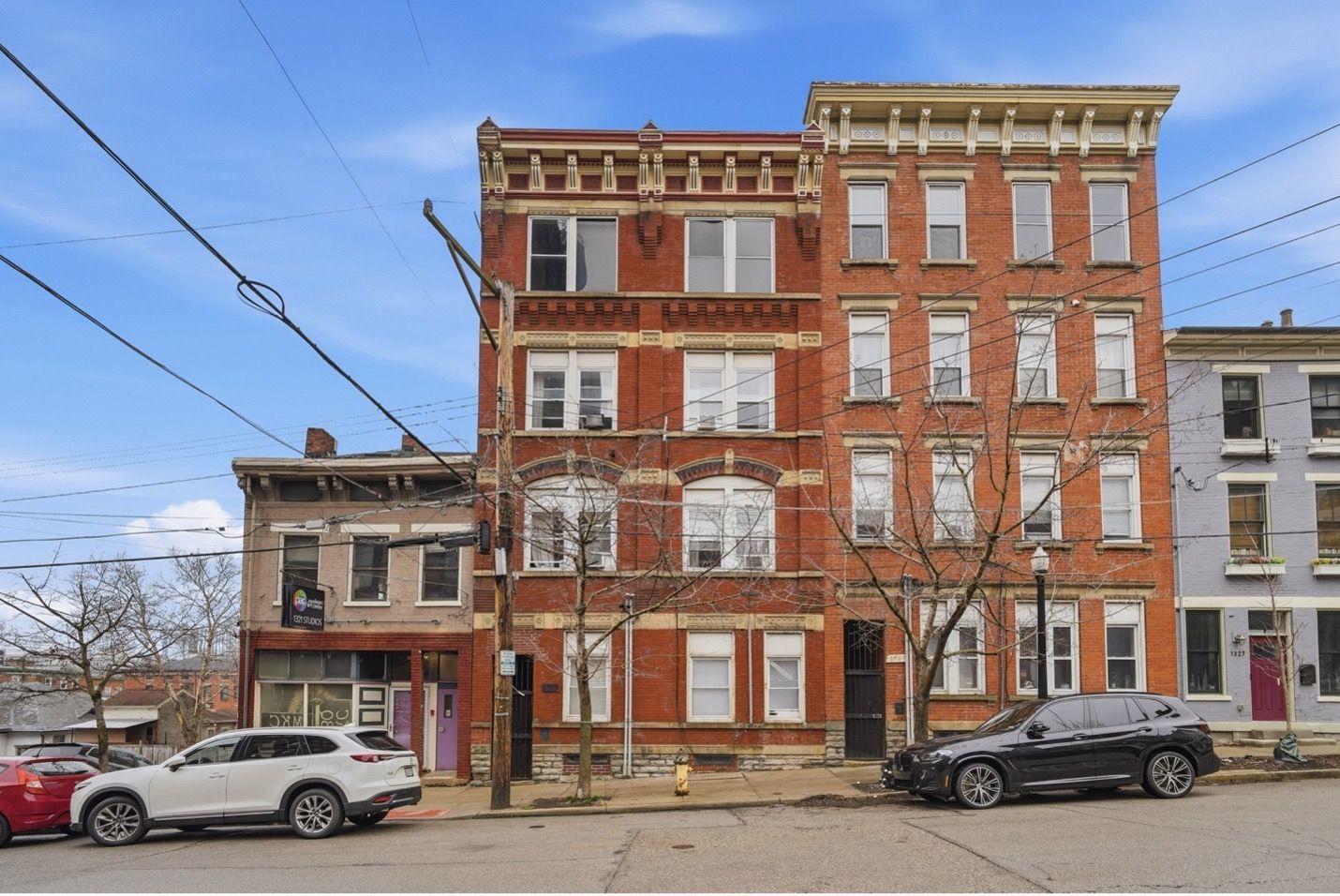 Tall residential buildings with alternating colored panels against a dark sky.
