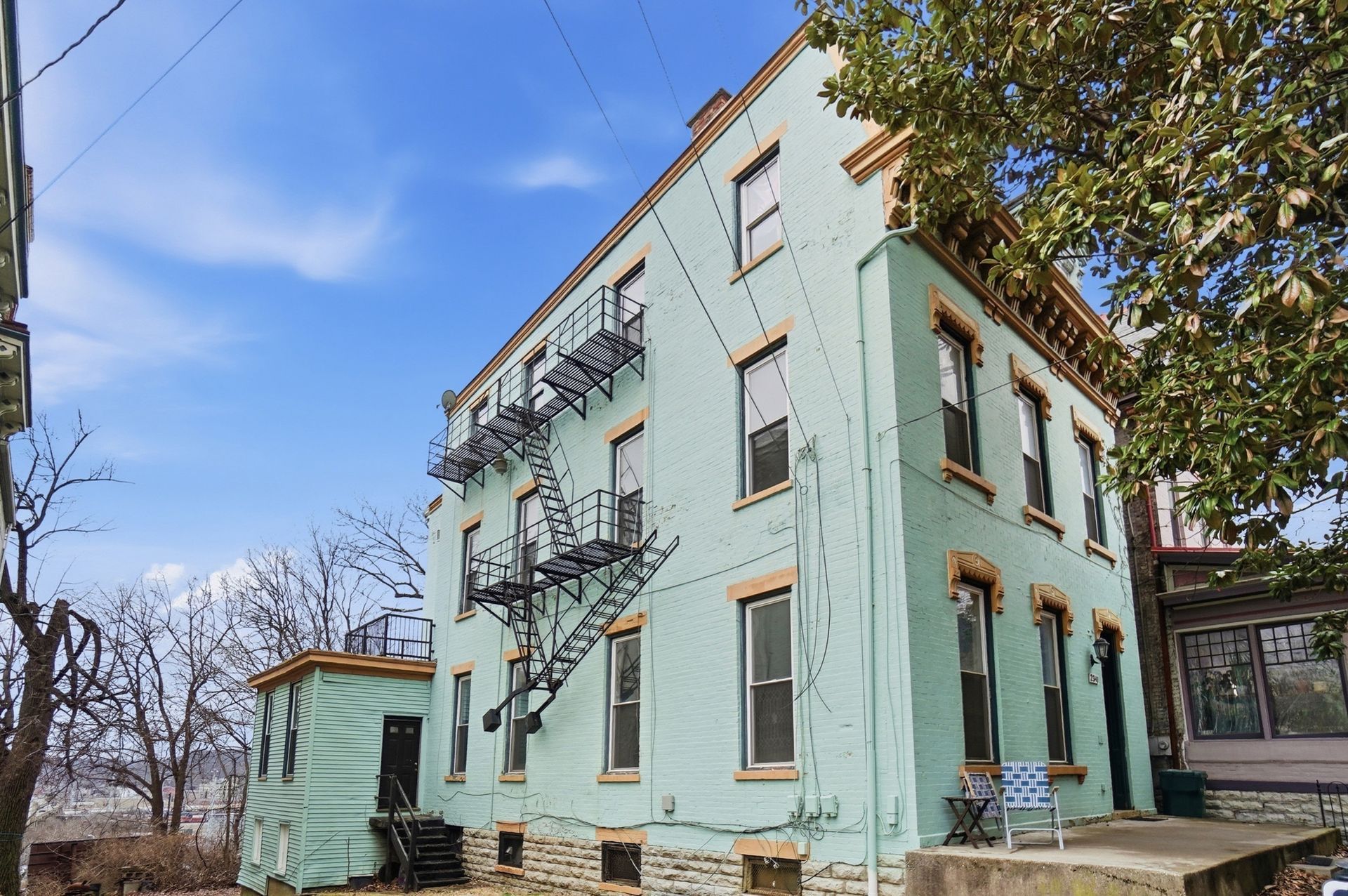 Low-angle view of tall buildings reaching into a partly cloudy sky.