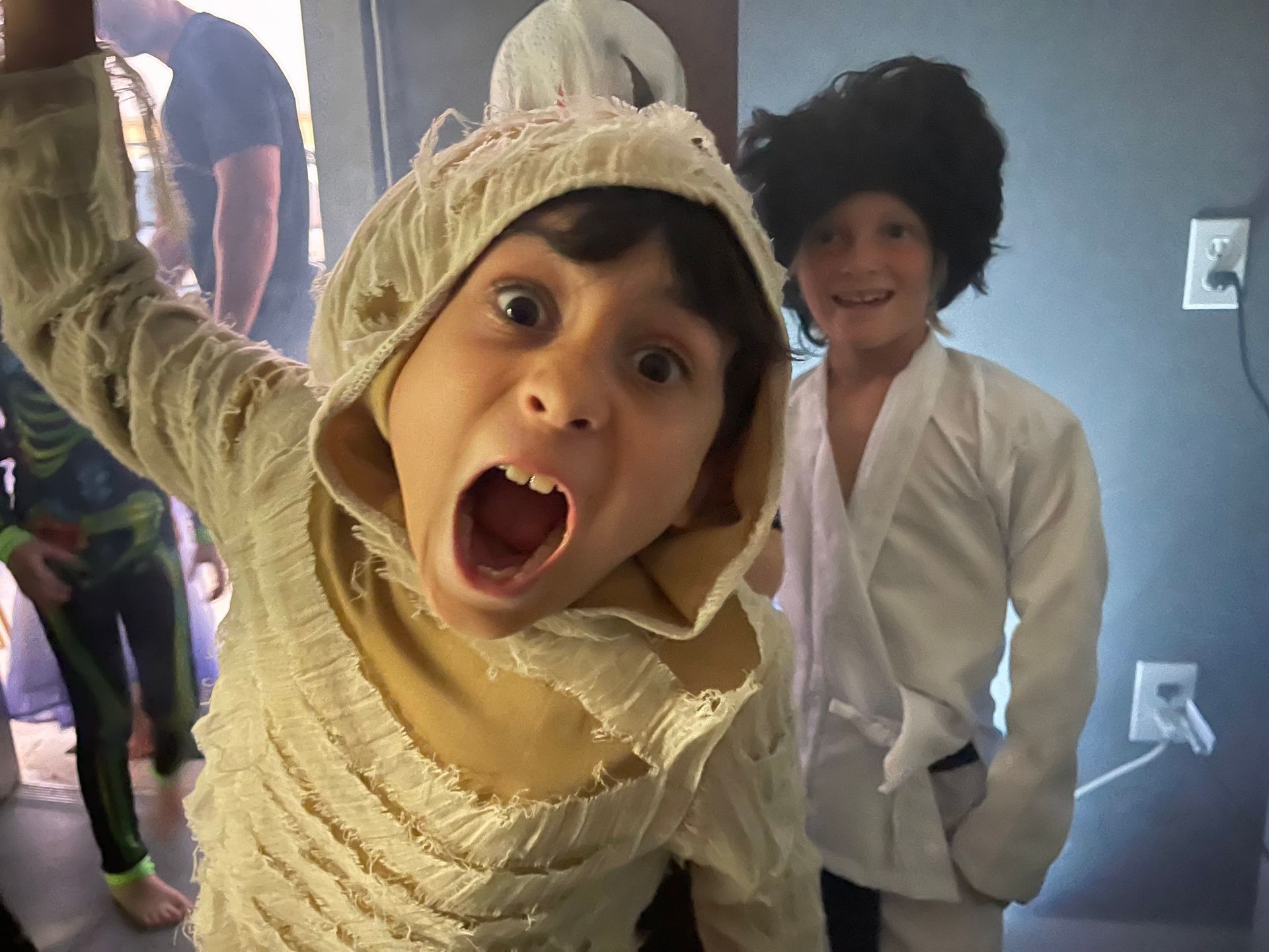 A young boy in a mummy costume with his mouth open