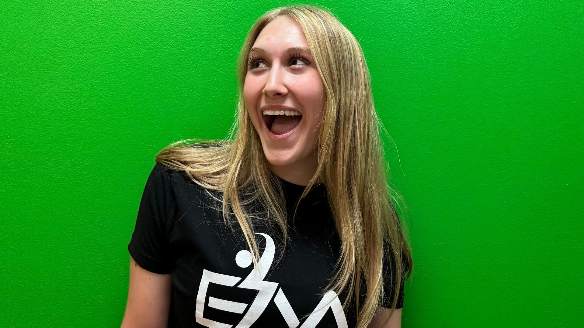 A group of people are putting their hands together in a circle.