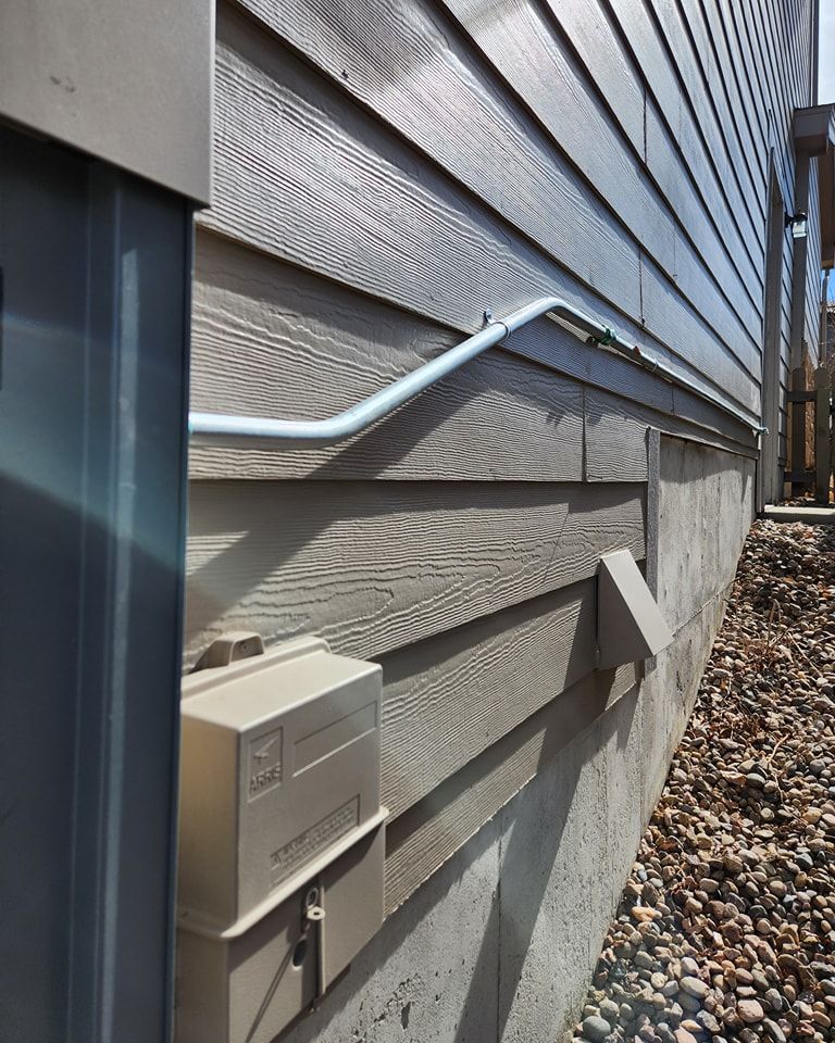 A close up of a house with a box on the side of it