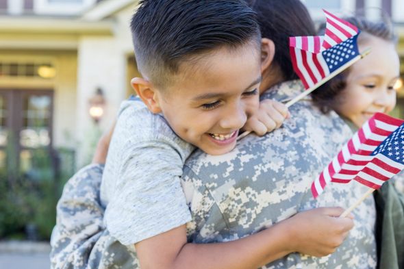 kids hugging military mom