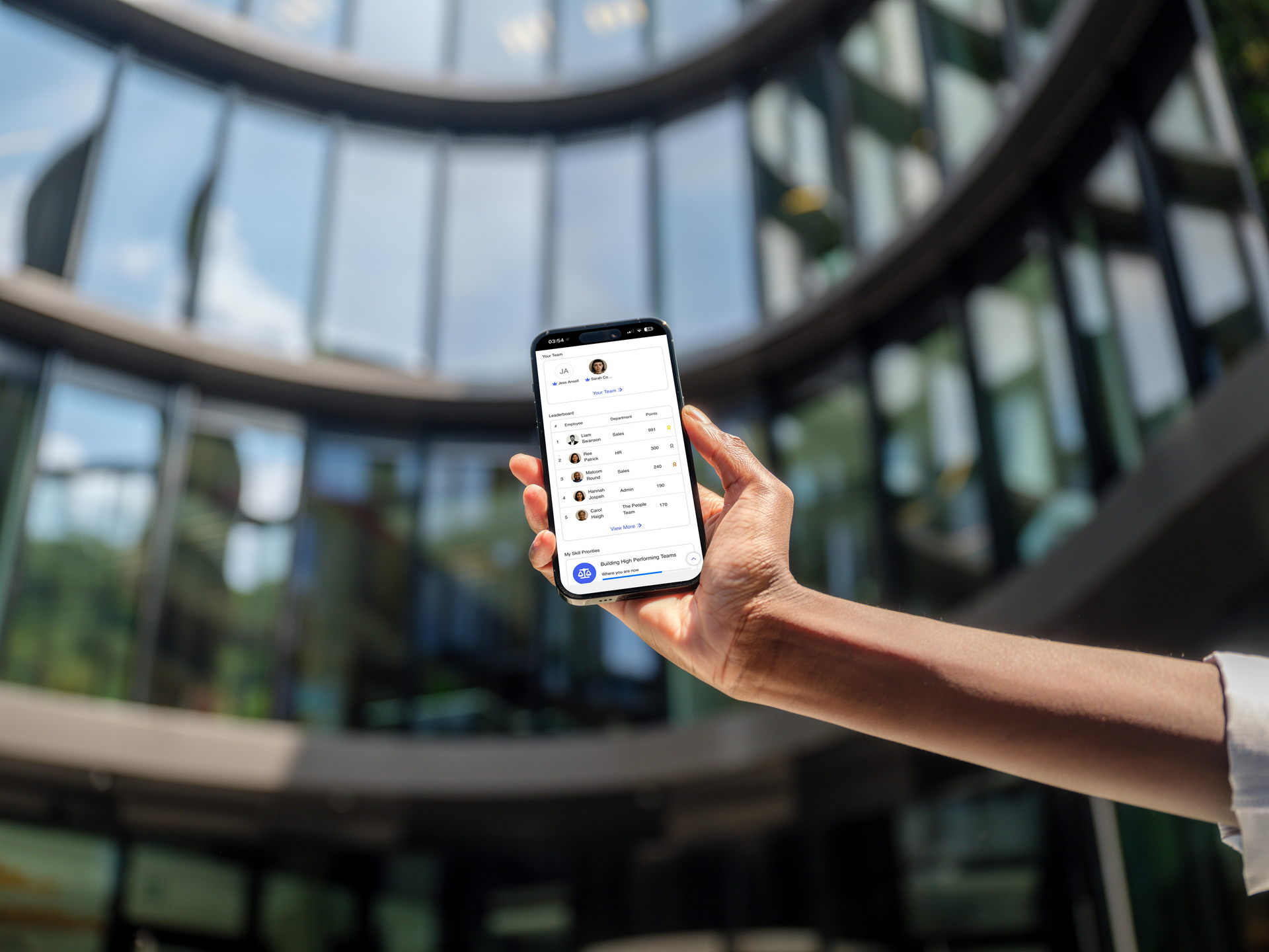A woman is wearing a headset while sitting at a desk in front of a computer.