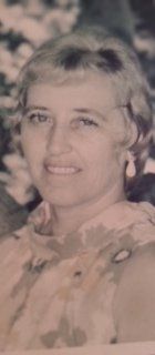 A woman is smiling in a black and white photo.