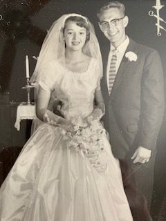 A black and white photo of a bride and groom posing for a picture on their wedding day