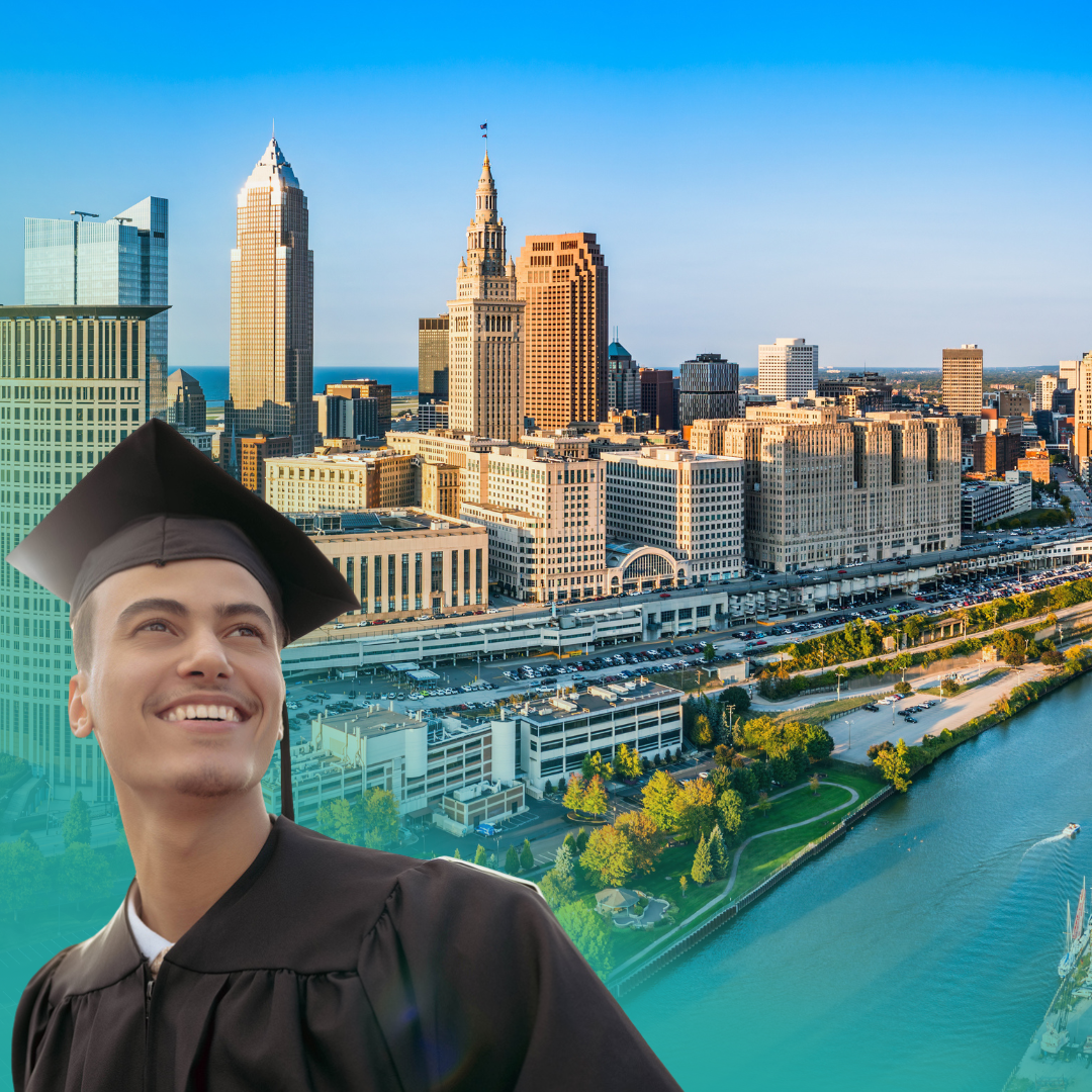 Graduating student with cap and gown smiles, overlooking a cityscape. Blue sky, river, and buildings.