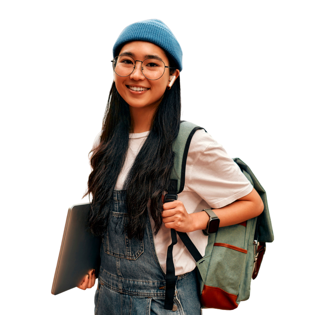 Young Black woman smiles while using a laptop, wearing a denim jacket and white shirt.