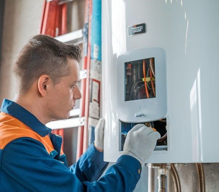 Technician installing a tankless water heater in a San Antonio home with clean, professional mounting