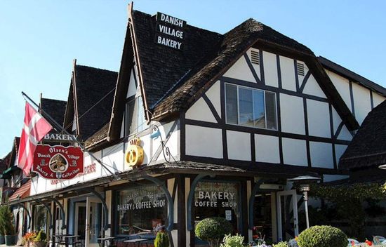 Danish-style bakery with black and white timber framing, sign reading 
