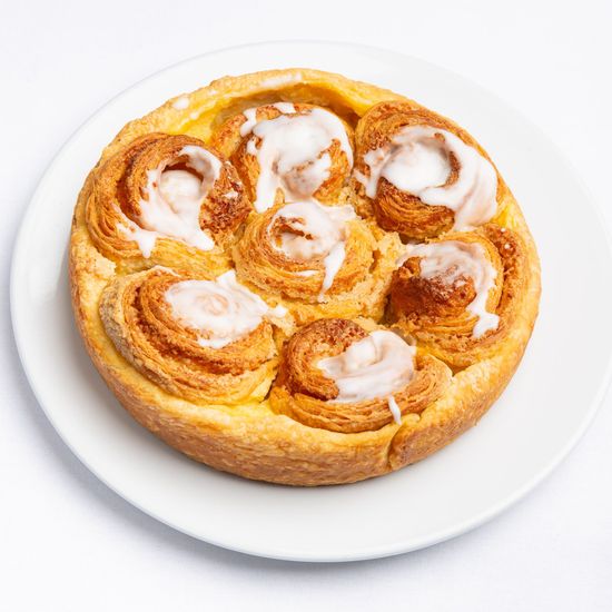 7 Sisters Coffee Cake with icing on a white plate.