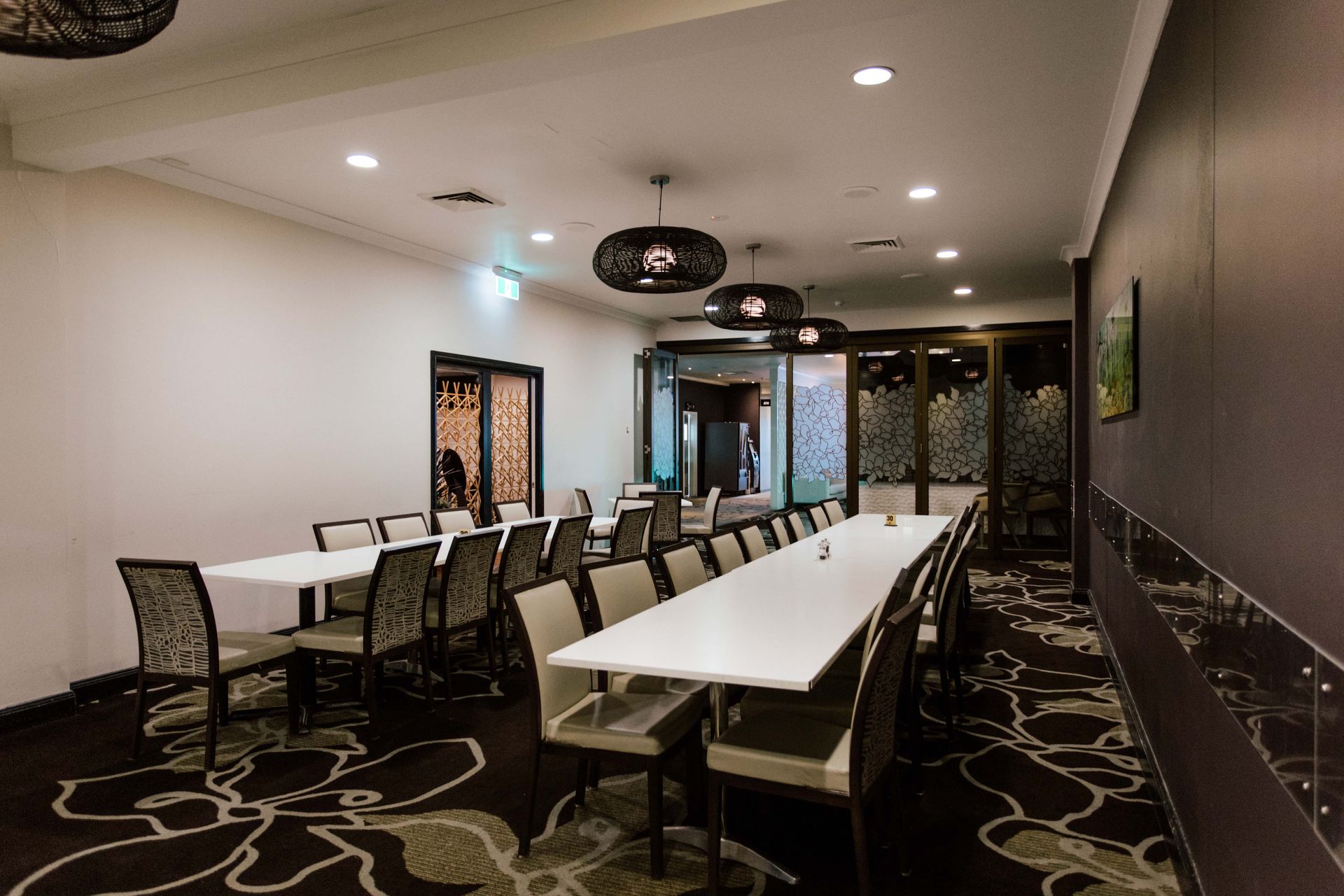 A dining room with a long table and chairs
