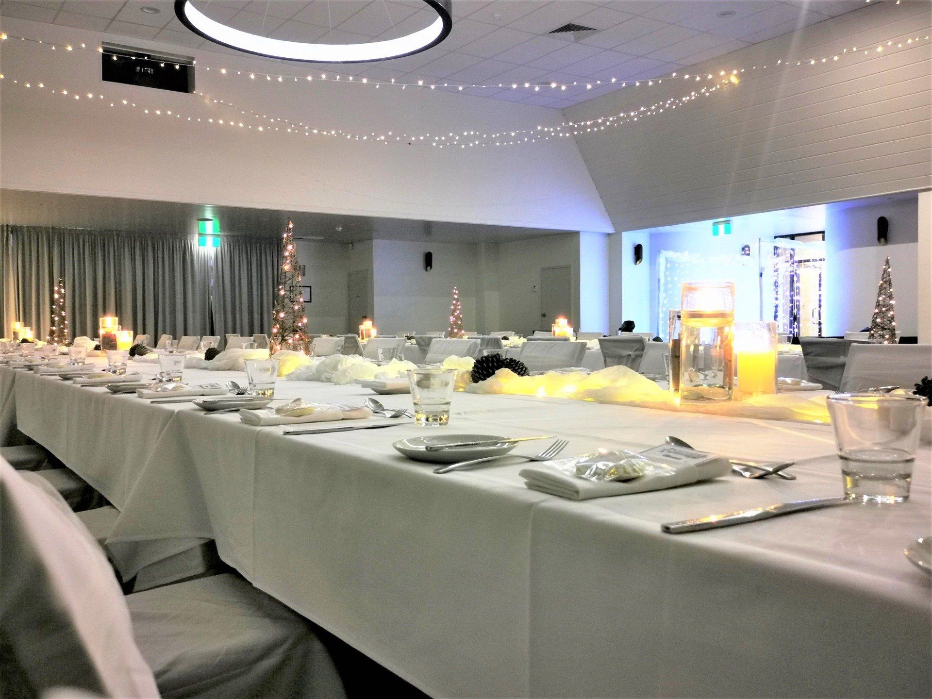 A long white table with a candle on it