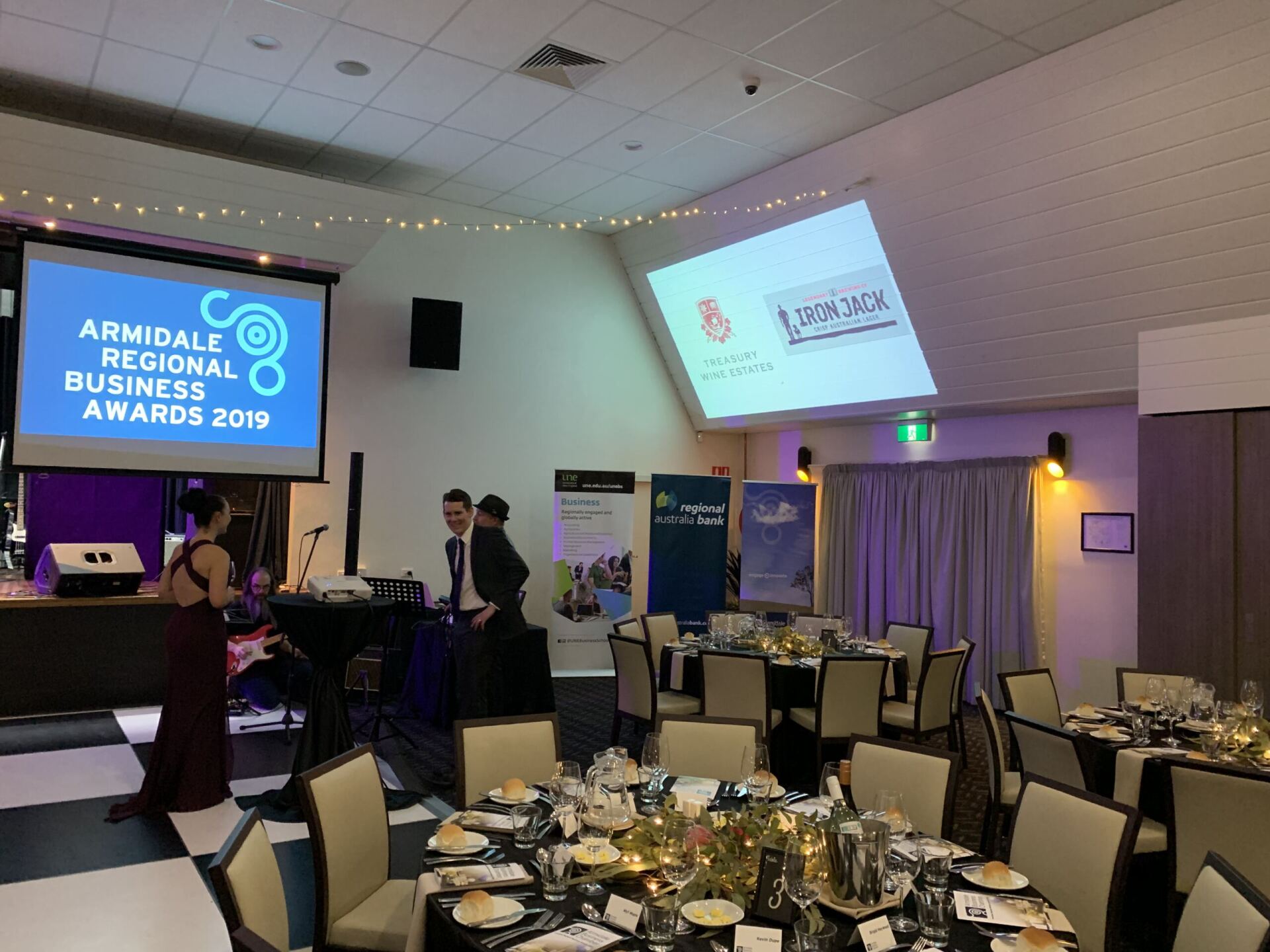 A large screen displays the Armidale regional business awards 2019
