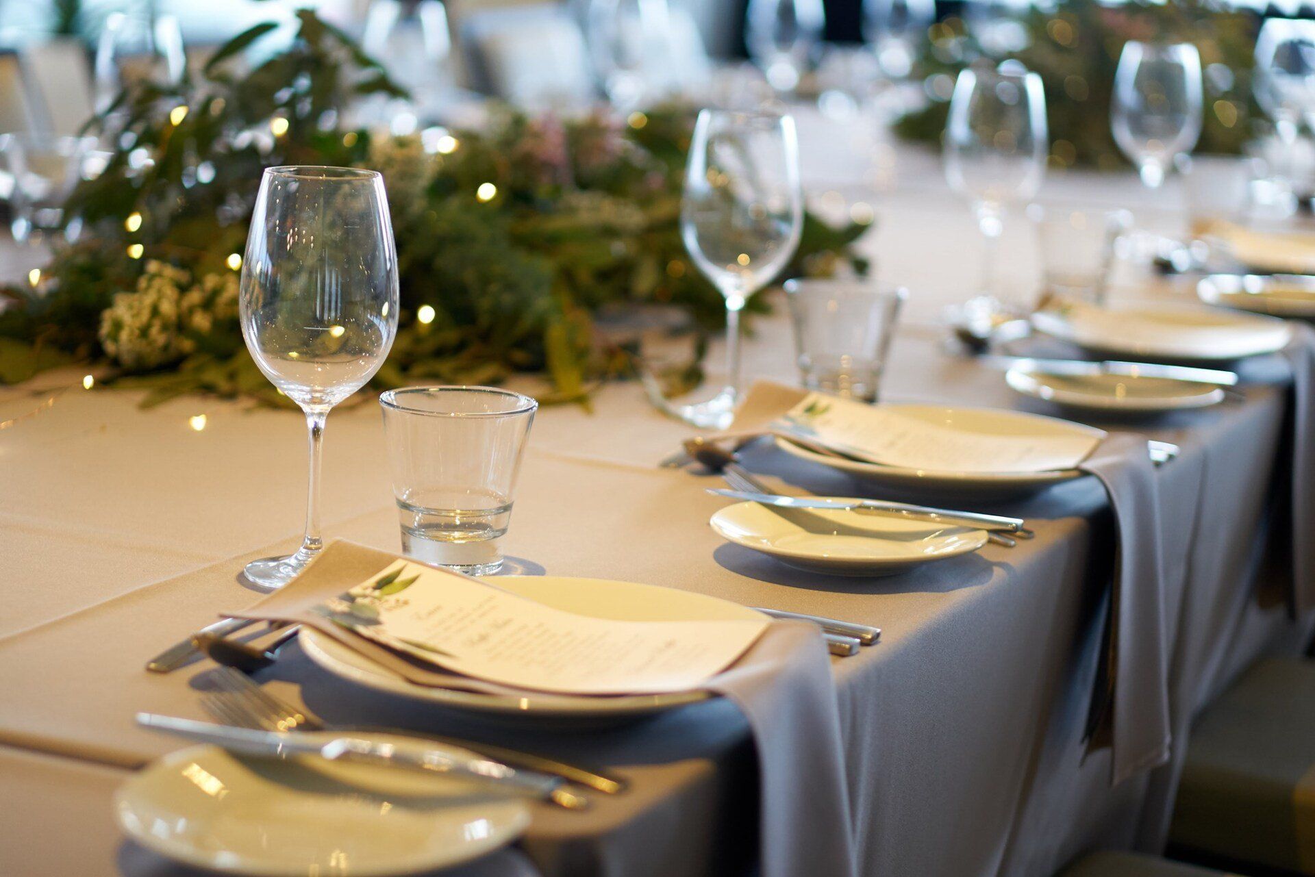 A long table with plates and wine glasses on it
