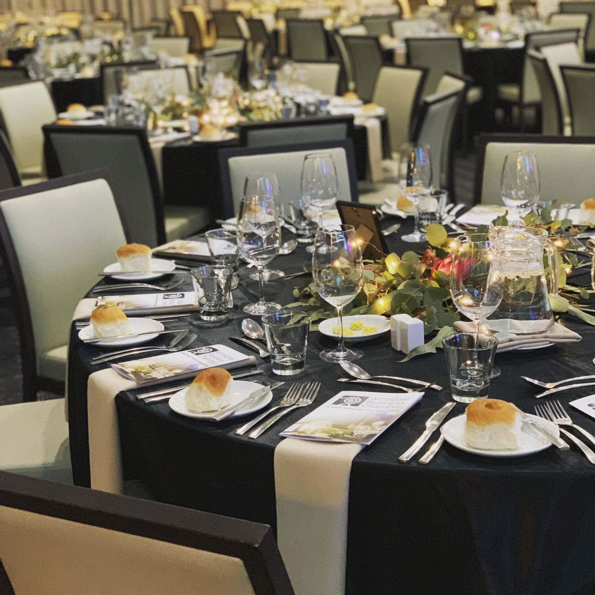 A large dining room with tables and chairs set for a banquet