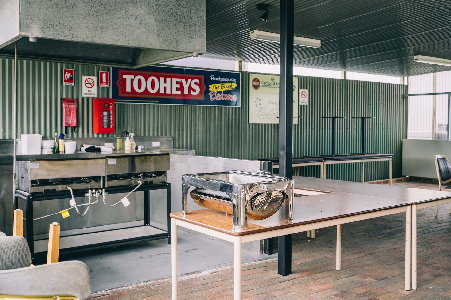 An outdoor barbecue area with a sign that says Tooheys