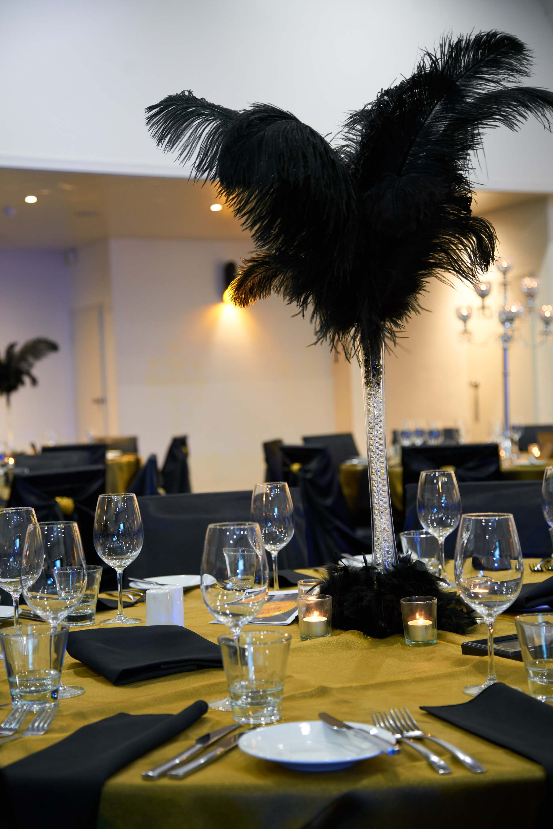 A table with a black feather in the center