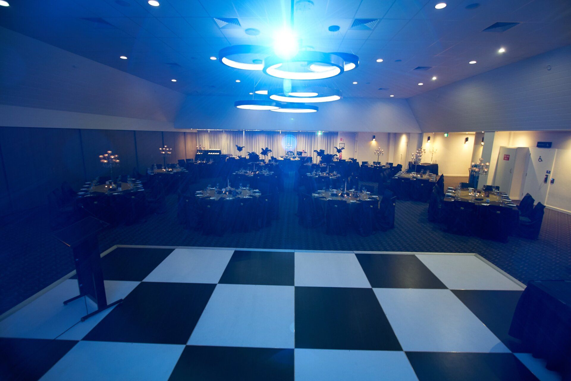 A black and white checkered dance floor in a large room