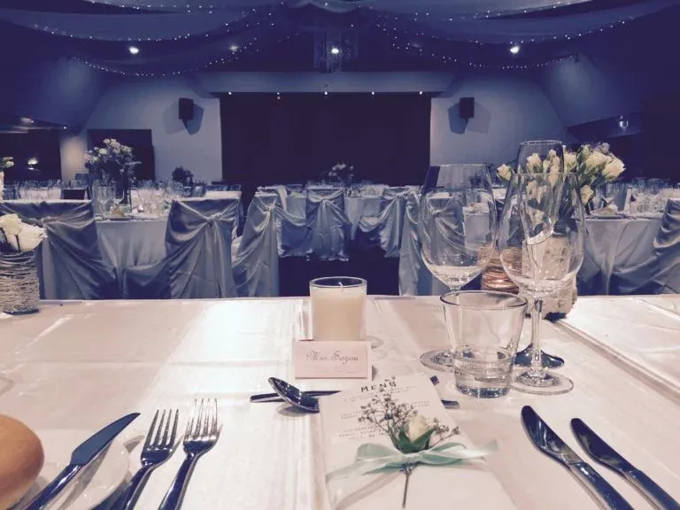 A table set for a wedding reception with a name tag