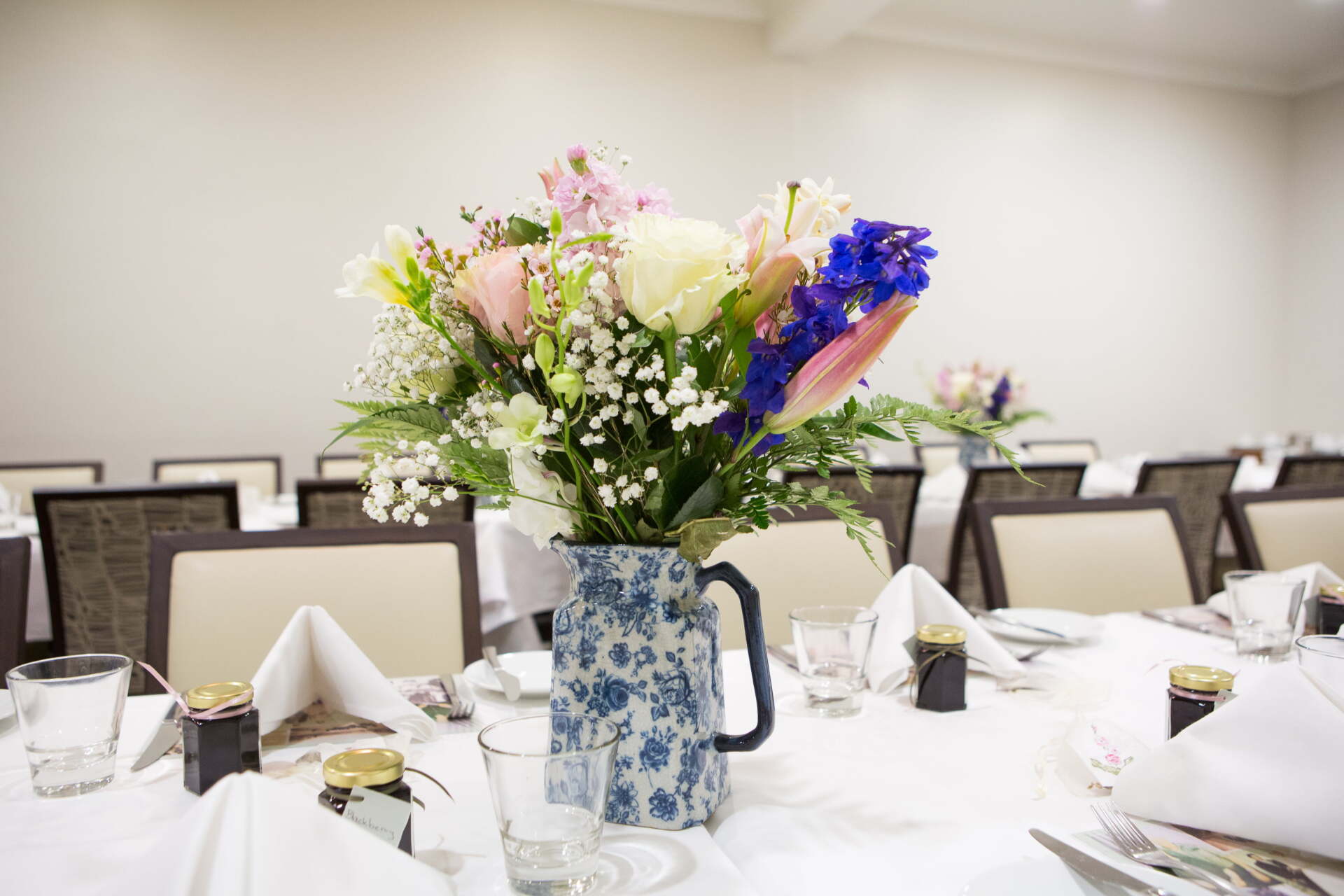 A vase filled with flowers sits on a table