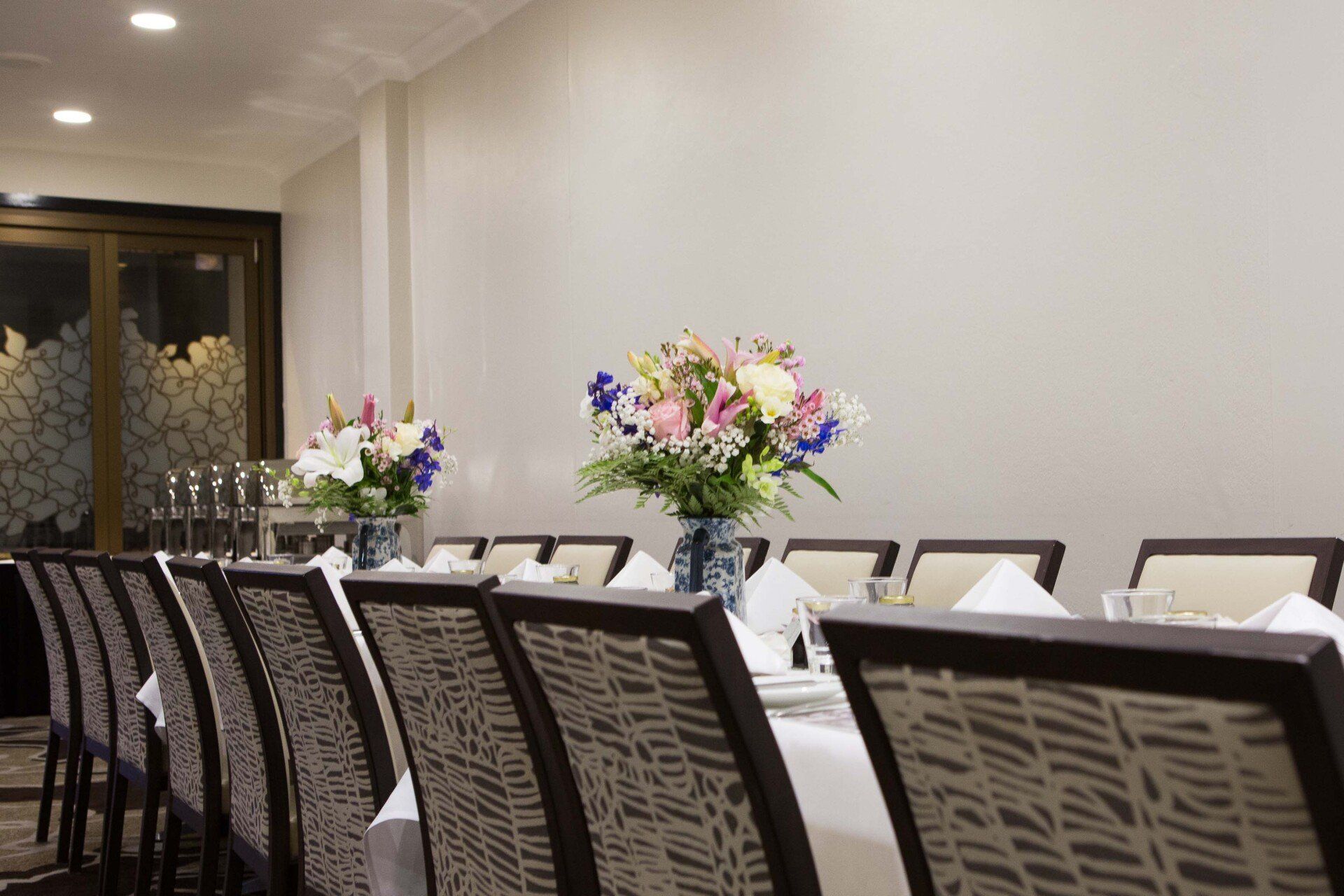 A long table with a vase of flowers on it
