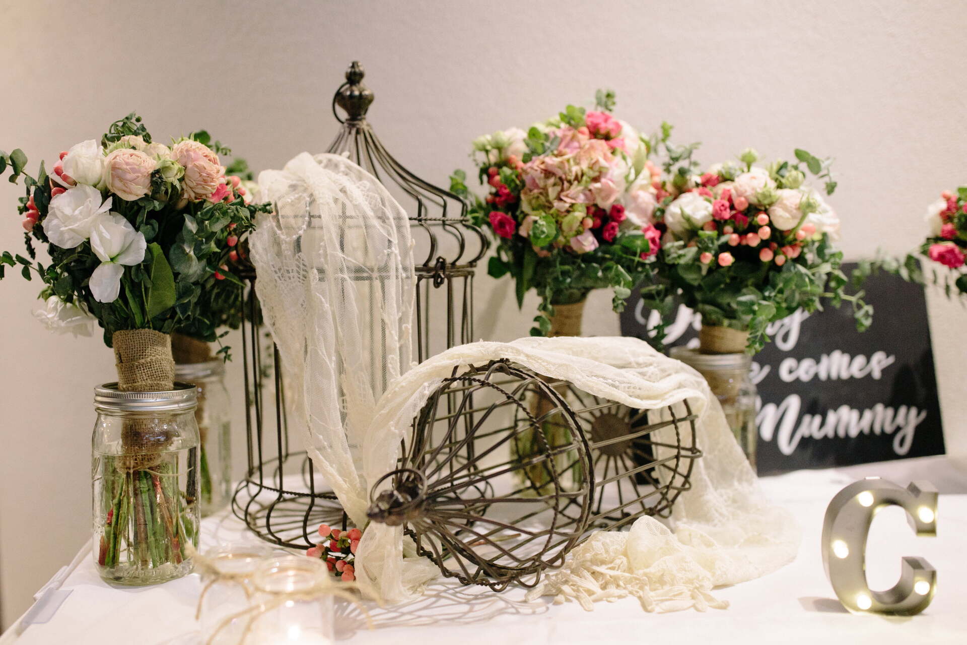 A table with flowers and a sign