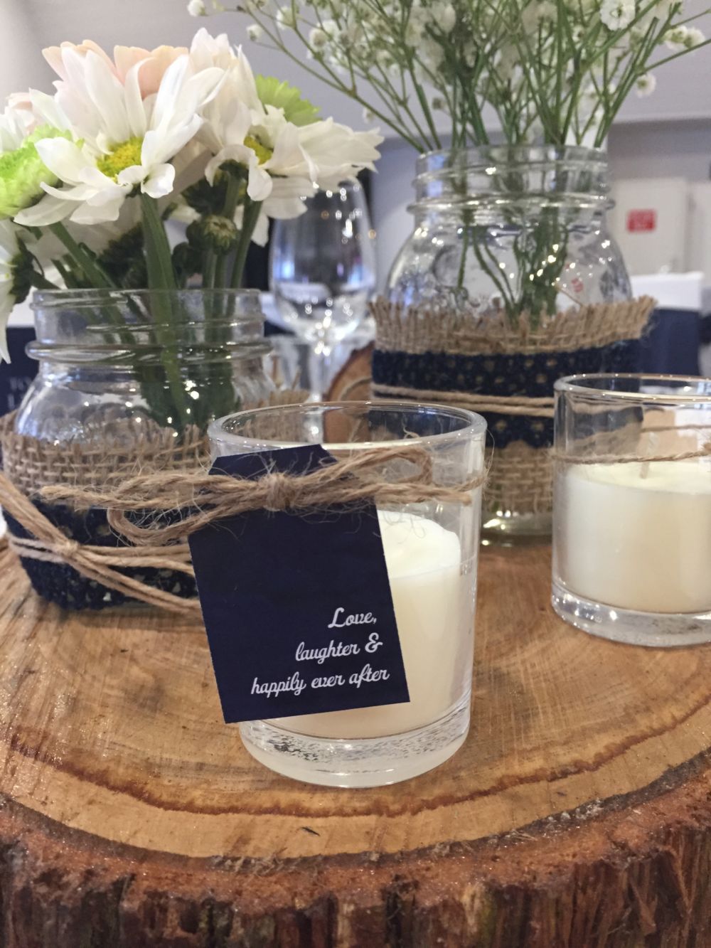A wooden stand with candles and flowers on it