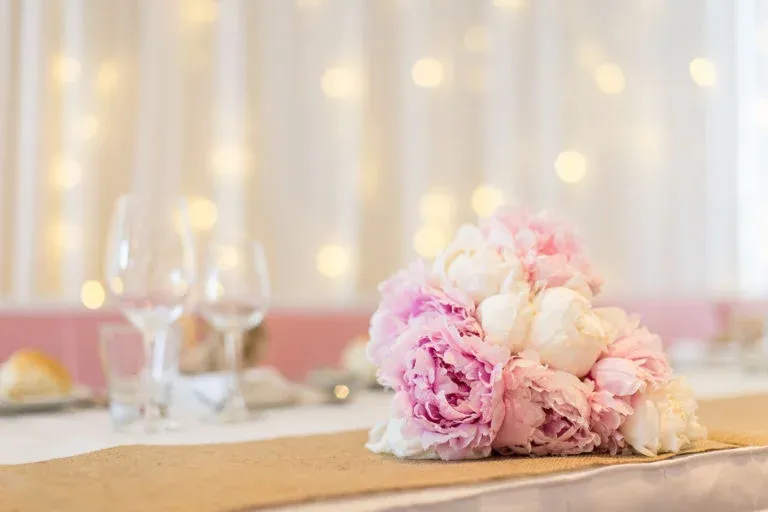 A bouquet of pink and white flowers is sitting on a table.