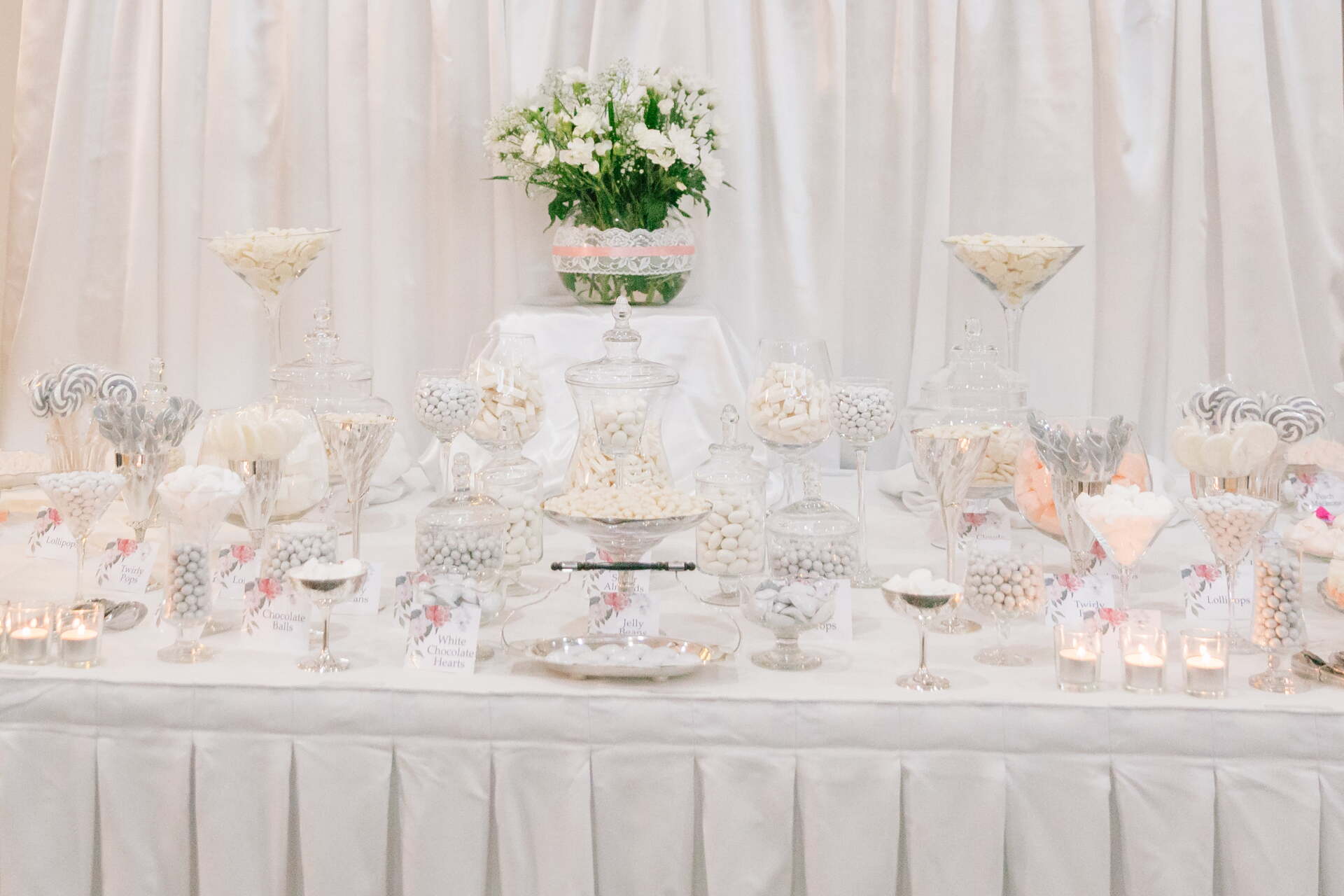 A table with an arrangement of wedding favours on it.