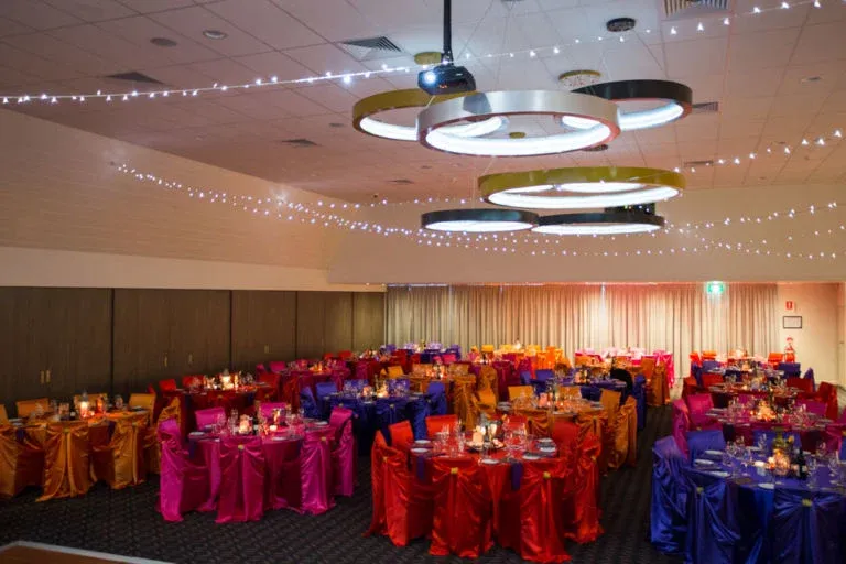 A large room with tables and chairs set up for a function
