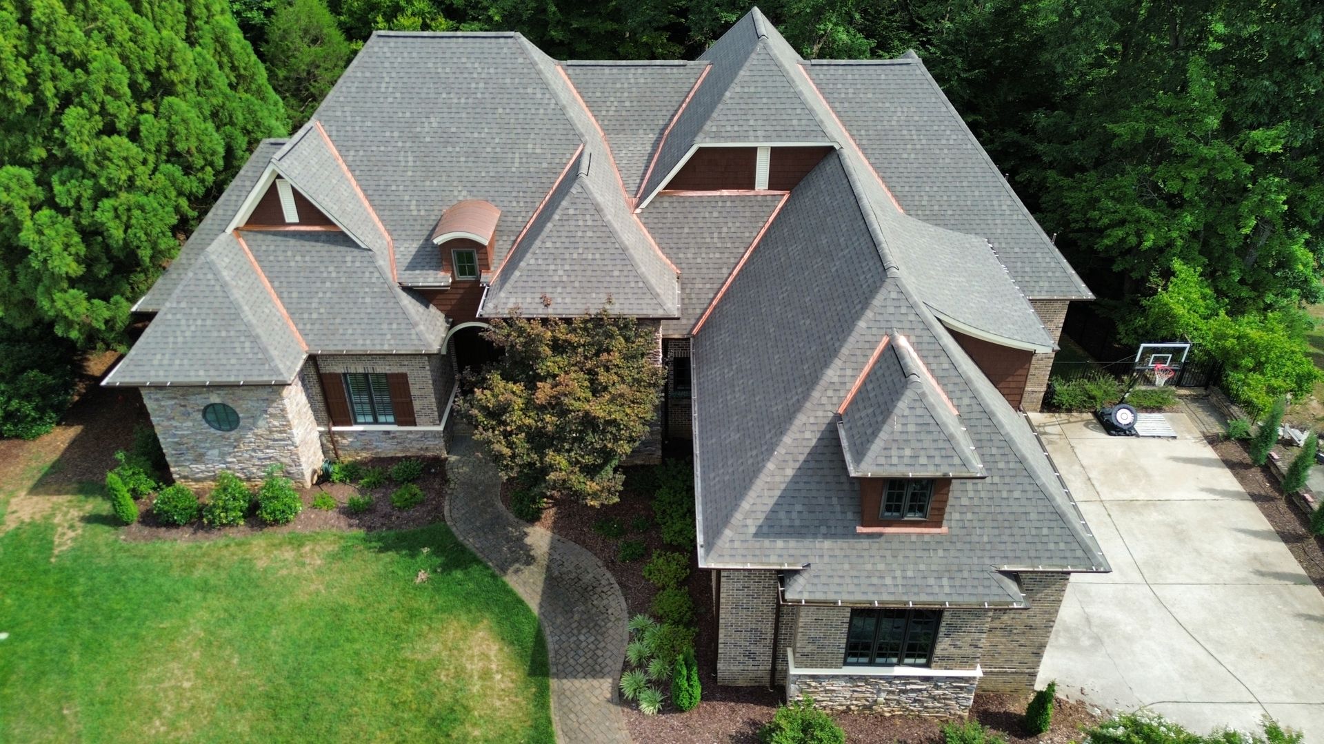 Beautiful new roof on home with copper valleys and copper dormer