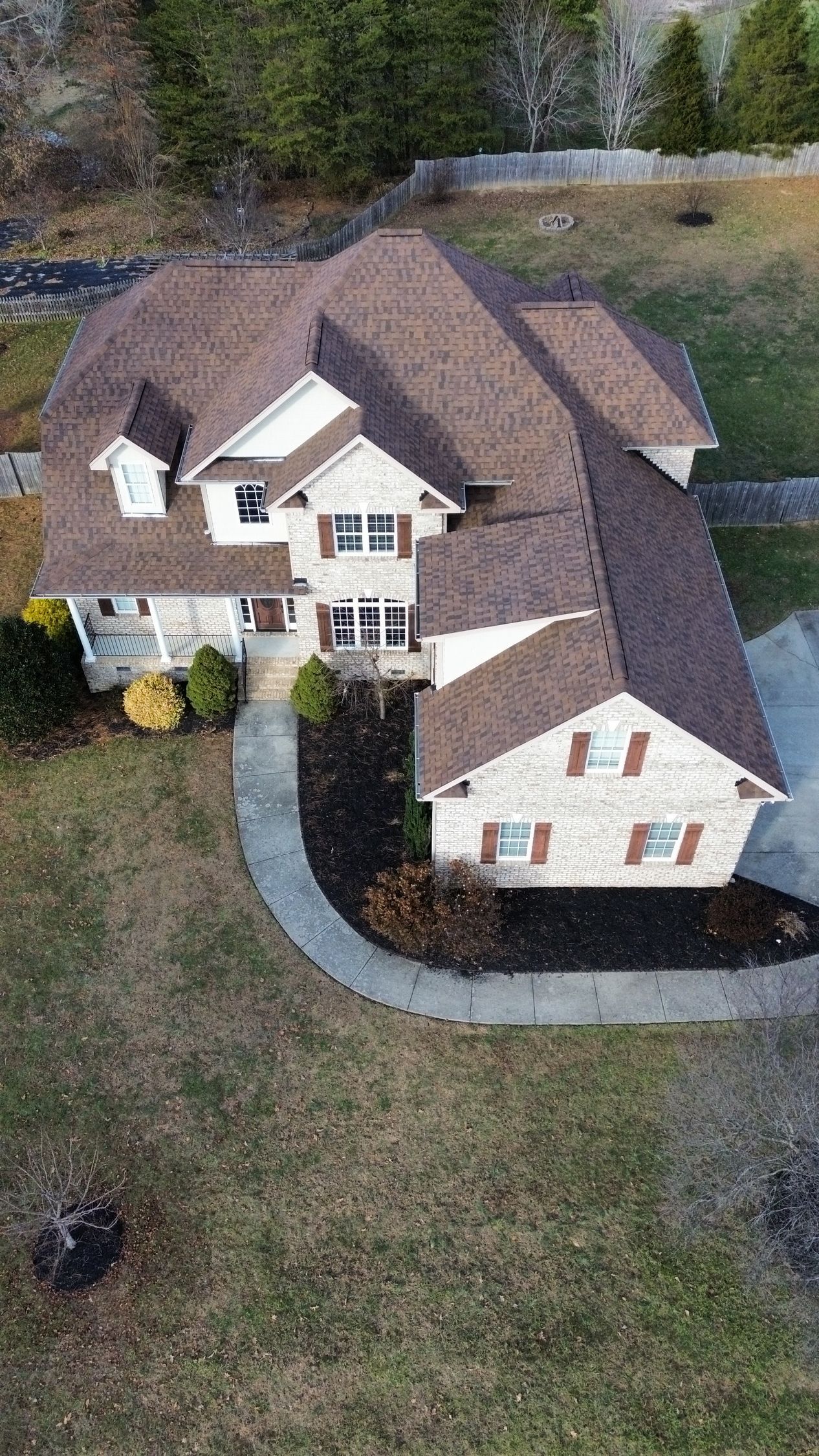 A beautiful home with new atlas brownwood shingles done by escalade roofing