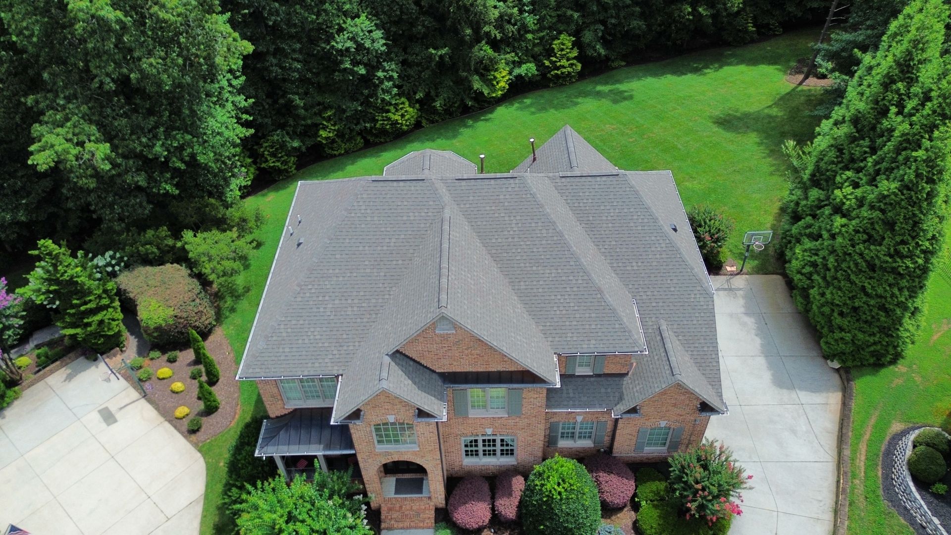 Beige house siding and gutter against a blue sky.