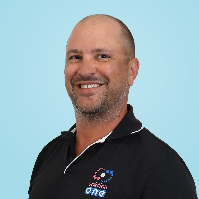 a man wearing a black shirt that says solution one