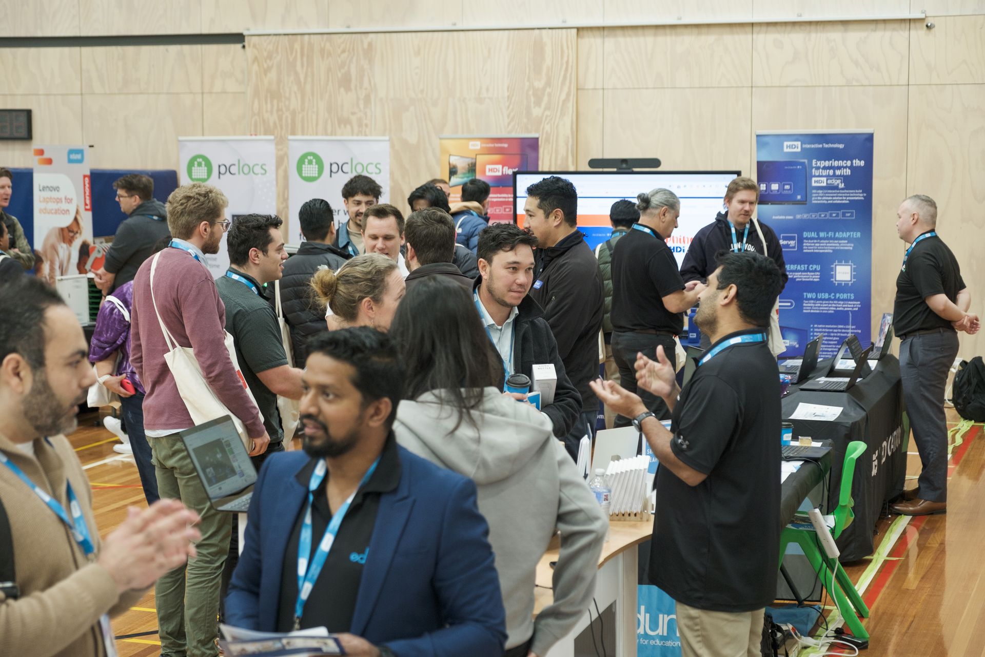 a group of people are sitting in an auditorium watching a presentation