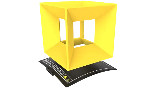 a yellow cube is sitting on top of a black mat .