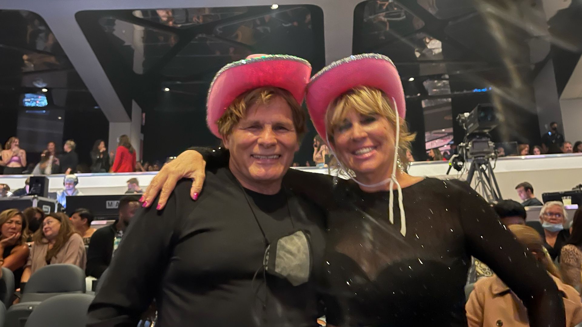 Mike and Barbara Ross wearing pink cowboy hats pose for a picture at Ava Max concert.