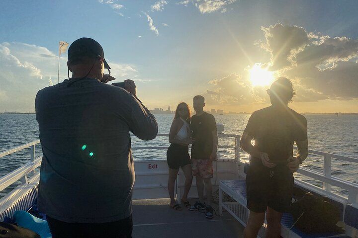 A group of people are taking pictures of the ocean on a boat.