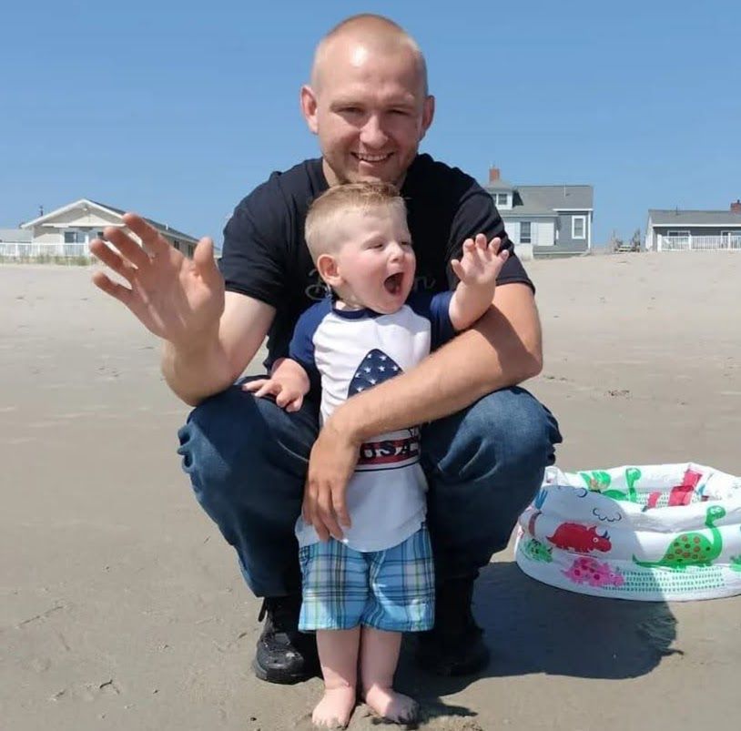 A large house with a brown roof and white trim